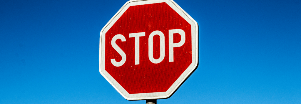 a stop sign with blue sky